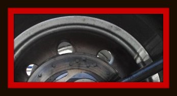 Dirty rear motorcycle wheel to be detailed by Fifty Dollar Detail.